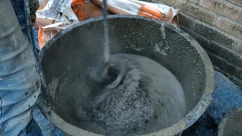 Construction Working Mixing Cement in Bucket with Concrete Mixer Close Up Stock Footage 109107853
