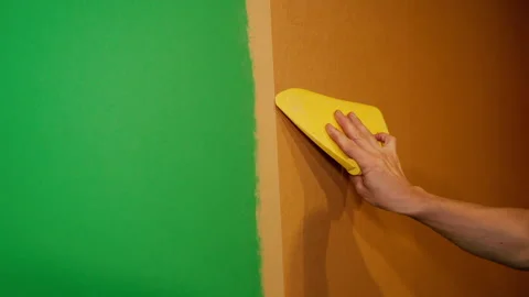 Construction works. The builder glues wallpaper in the apartment. Stock Footage 168027479