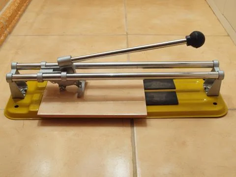Construction works- ceramic tile cutter with tile. Stock Photos