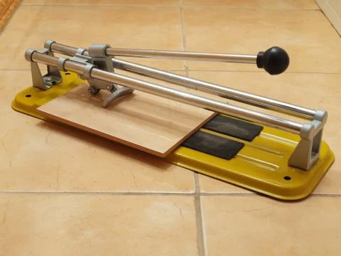 Construction works- ceramic tile cutter with tile. Stock Photos