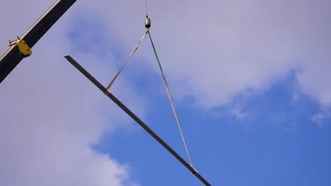 Construction works. Crane lifting a metal beam. Stock Footage 342596693