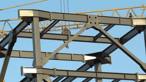 Construction works high on a skyscraper construction site, big steel parts in Video stock 233735193