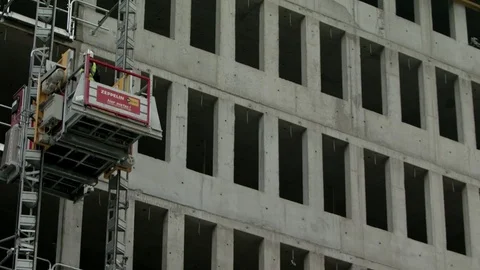 Construction works at a shell, elevator passes by, close up Stock Footage 82446976