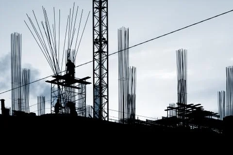Construction works: silhouettes of 3 workers Stock Photos