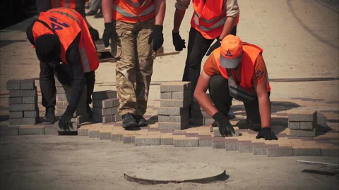Construction works. A worker pours crushed stone with a shovel. Road constructio Stock Footage 155216893