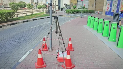 Construction zone barriers with orange traffic cones surrounding a tripod 스톡 동영상 322637150