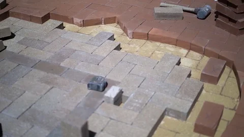 Construction zone detail of brick paver custom emblem in herringbone pattern. Stock Footage 82023114