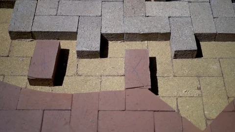 Construction zone detail of brick paver custom emblem in herringbone pattern. Stock Footage 82023152