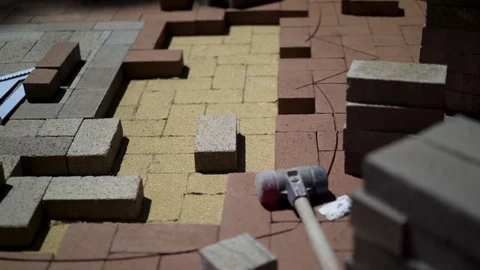 Construction zone detail of brick paver custom emblem in herringbone pattern. Stock Footage 82023168