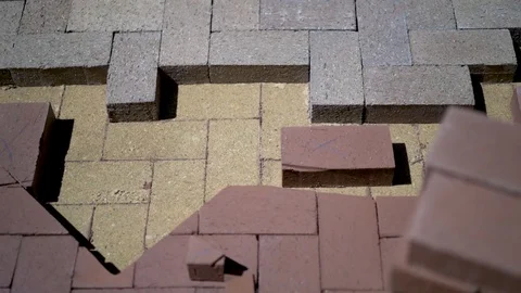 Construction zone detail of brick paver custom emblem in herringbone pattern. Stock Footage 82023226