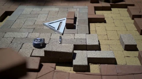 Construction zone detail of brick paver custom emblem in herringbone pattern. Stock Footage 82023252