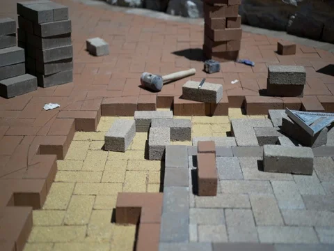 Construction zone detail of brick paver custom emblem in herringbone pattern. Stock Footage 82041569