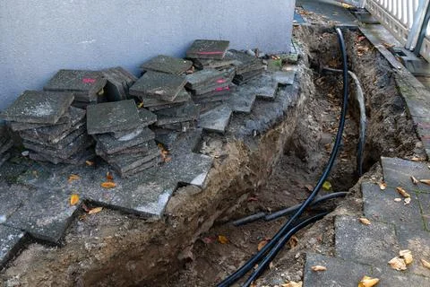 Construction zone with exposed cables and stacked tiles Stock Photos