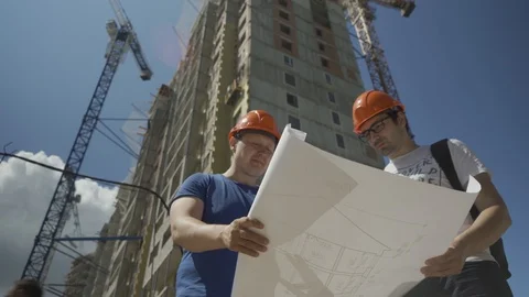 Construction.Architect.Two young architects at the construction site.Two 動画素材 112140867