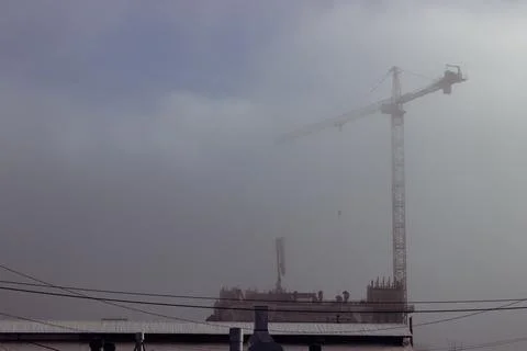 Constructions with crane in fog Stock Photos