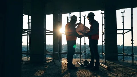 Constructions planning held by two construction engineers at the building lot Stock Footage 119092055