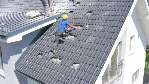 Constructions Workers Inspecting Roof Tiling Of House. Aerial Parallax Stock Footage 135850522