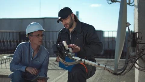 Constructor and taskmaster discussing Stock Photos