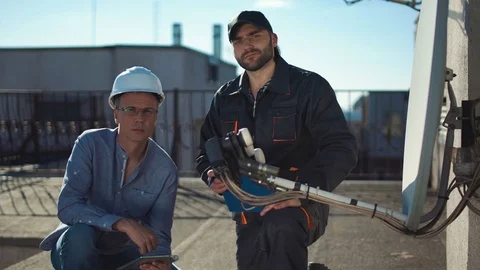 Constructor and taskmaster looking at camera Stock Footage 77429001