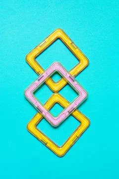 Constructor children plastic yellow colored on a pastel blue Foto stock