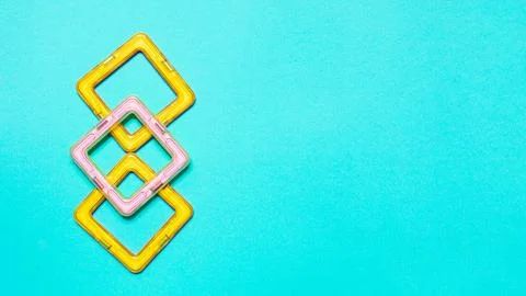 Constructor children plastic yellow colored on a pastel blue Stock Photos