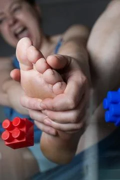 Constructor Experiences Foot Pain While Handling Toys at Home With a Child Stock Photos