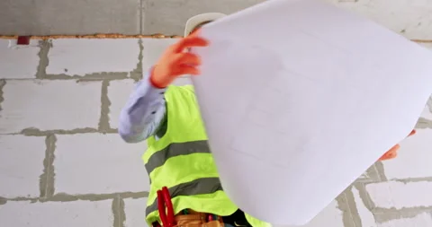 Constructor inspects ceiling and building scheme at renovation Vídeos de archivo 309082854