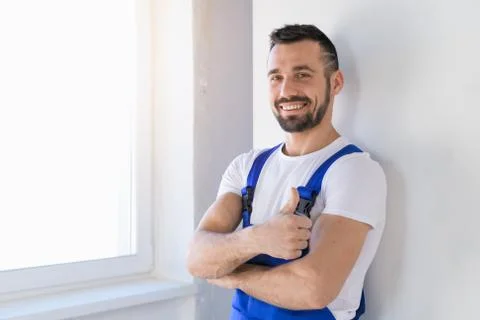 Constructor in overalls folded his arms over his chest Stock Photos