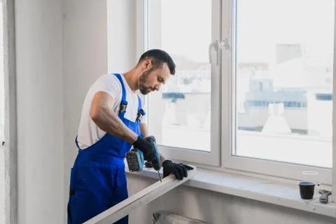 Constructor in overalls folded his arms over his chest Stock Photos