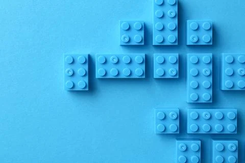 Constructor toy. Many building blocks on light blue background, flat lay Fotos de archivo