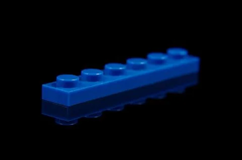 Constructor toy plastic brick close up isolated on the black Stock Photos