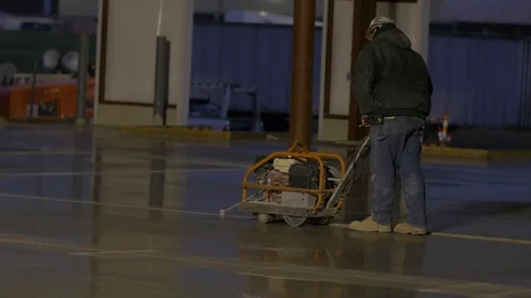 Constrution Worker in Hardhat using Concrete Saw Stock Footage 101390363