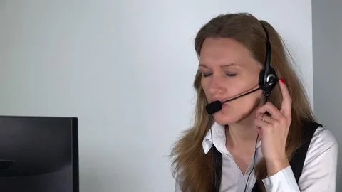 Consultant working with headphones on tedious work at computer in office. Stock Footage 140490235