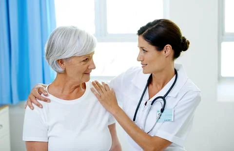 Consultation, doctor and old woman in hospital for advice, help and support at Stock Photos