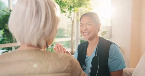 Consultation, high five and old woman with nurse for conversation, support or Stock Footage 341387575