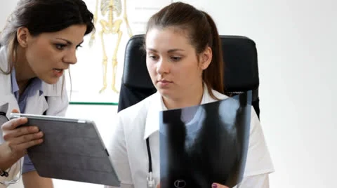 Consultation X-ray results with tablet in doc office - tracking shot Stock Footage 22934590