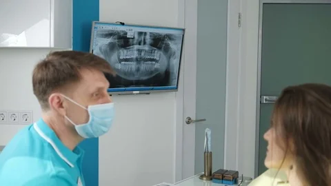 On the consultations of a successful dentist. They use the screen for discussion Stock Footage 74444341