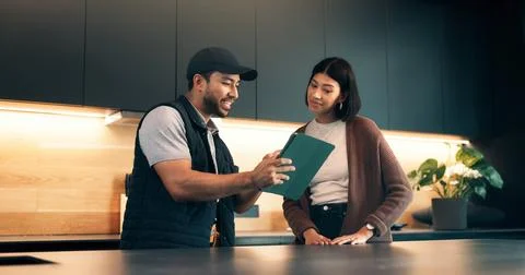 Consulting, client and tablet with handyman in kitchen for invoice agreement Stock Photos