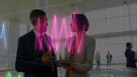 Consulting colleagues in suits analyzing tablet data causing 3D wave grid in Stock Footage 332289602