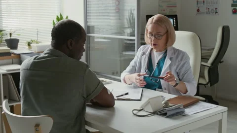 Consulting Patient about Glucose Level Monitoring Application in Clinics Stock Footage 310320231