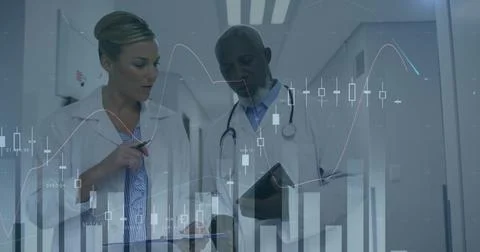 Consulting two doctors checking tablet in hospital corridor, wearing lab coats, 스톡 사진