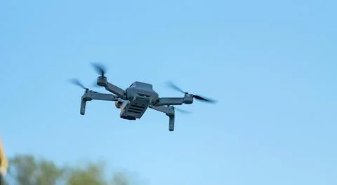 Consumer drone with camera hovering against sky with copy space Stock Photos