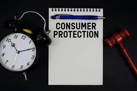 Consumer Protection text written on notepad with gavel and alarm clock on b.. Stock Photos