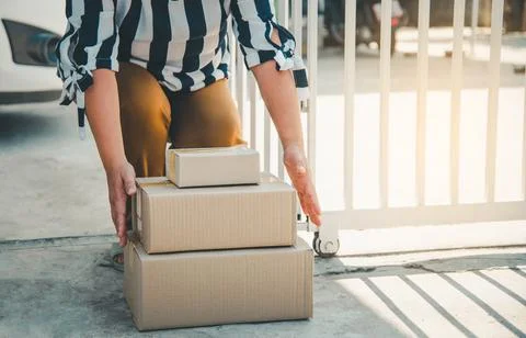 The consumer took the parcel that he ordered online and placed in front of th Stock Photos