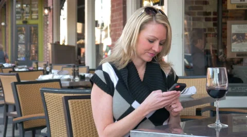 Consumer woman using touchscreen smart phone at cafe Video stock 48934683