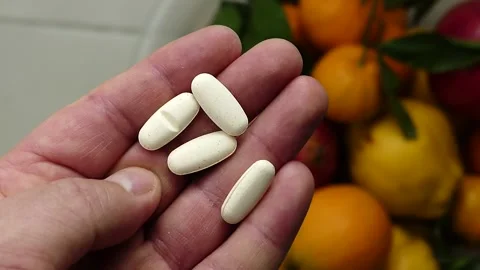 Consuming natural fruit instead of vitamin pills, comparison with vitamin pil Stock Footage 166704324