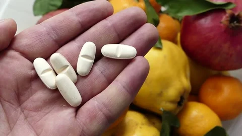 Consuming natural fruit instead of vitamin pills, comparison with vitamin pil Stock Footage 166704851