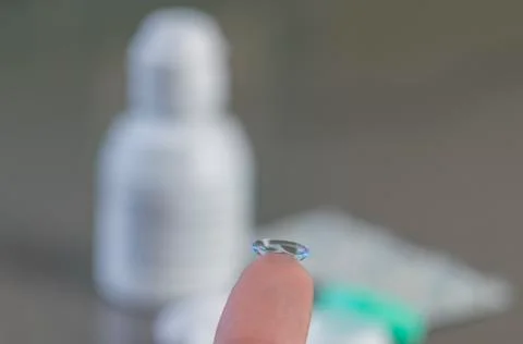 Contact lens bended in wrong direction on finger isolated Foto stock