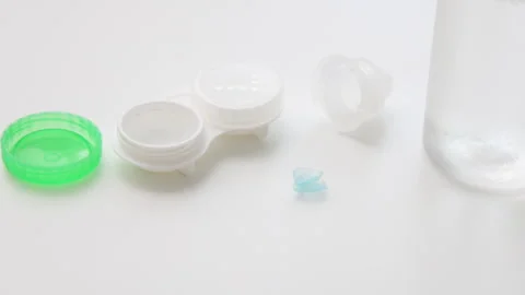 Contact lens solution pouring on lenses on woman finger. Stock Footage 247173576