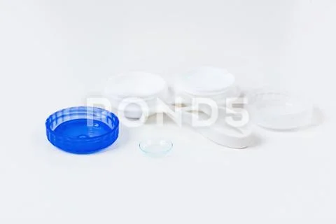 Contact lenses in containers with tweezers. Stock Photos